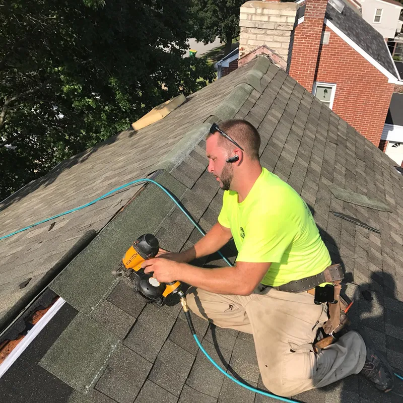 J.W. Tull roof repair technician working on a roof