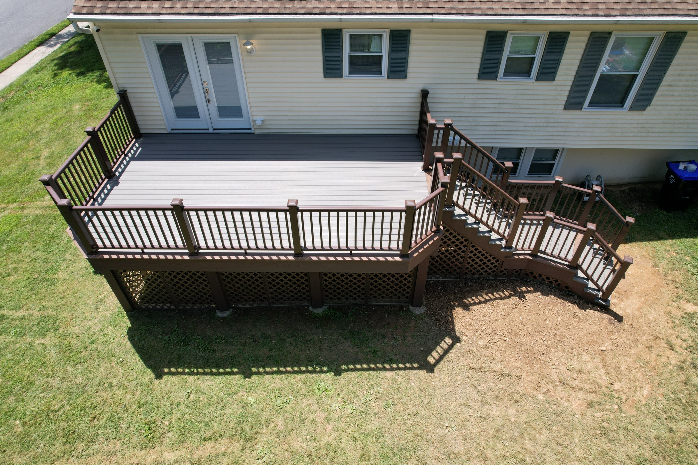 Overhead aerial view of a completed residential deck with stairs and railings